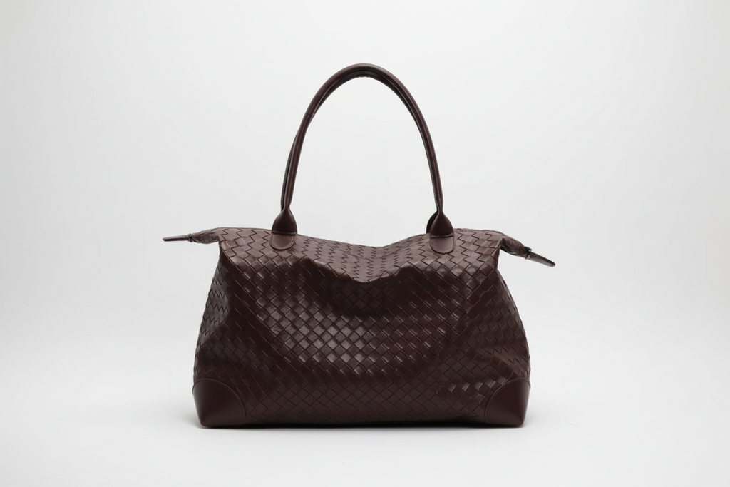 Brown woven handbag on a white background