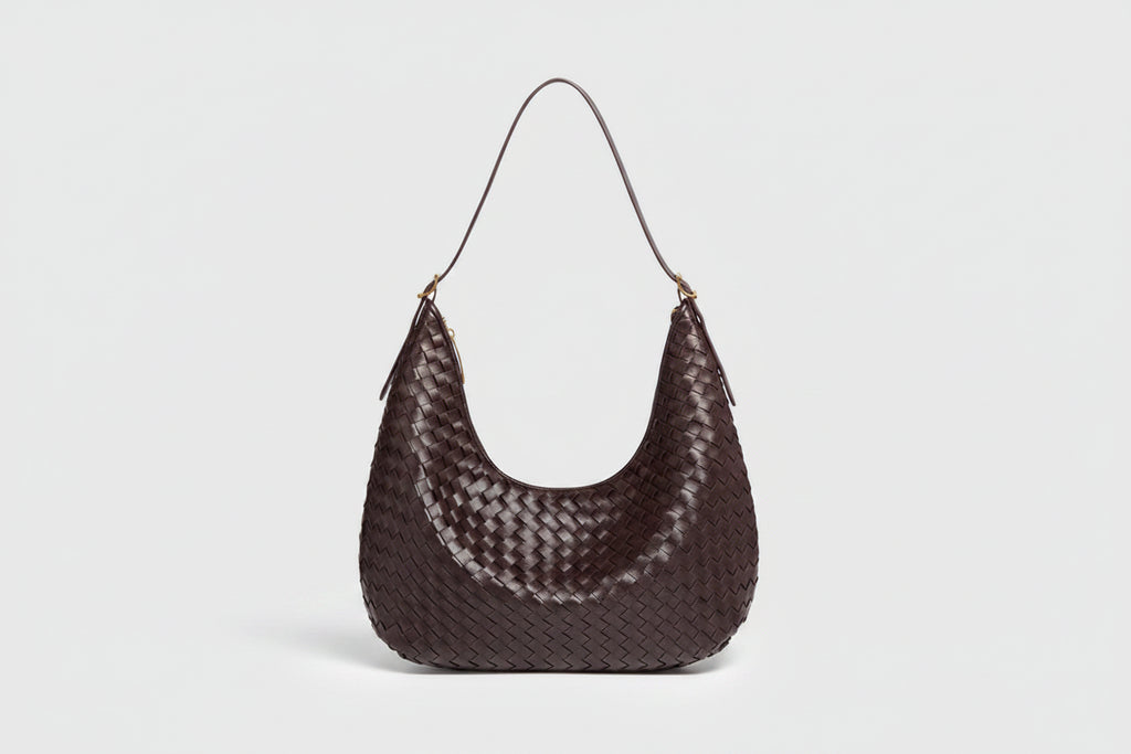 Brown woven handbag on a white background