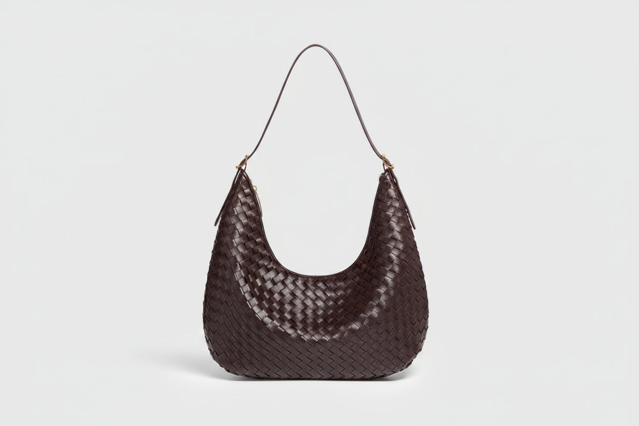 Brown woven handbag on a white background